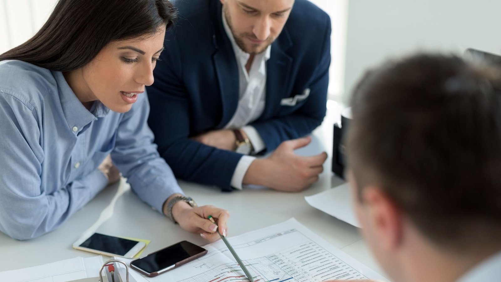 Advisors analysing financial reports for a college turnaround